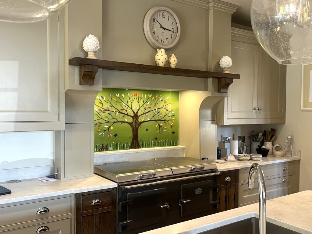 Close view of a bespoke Tree of Life fused glass splashback with green and multicoloured detail.