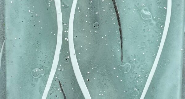 Semi-transparent grey fused glass panel with flowing white and silver lines, measuring 89.5 x 30 cm.